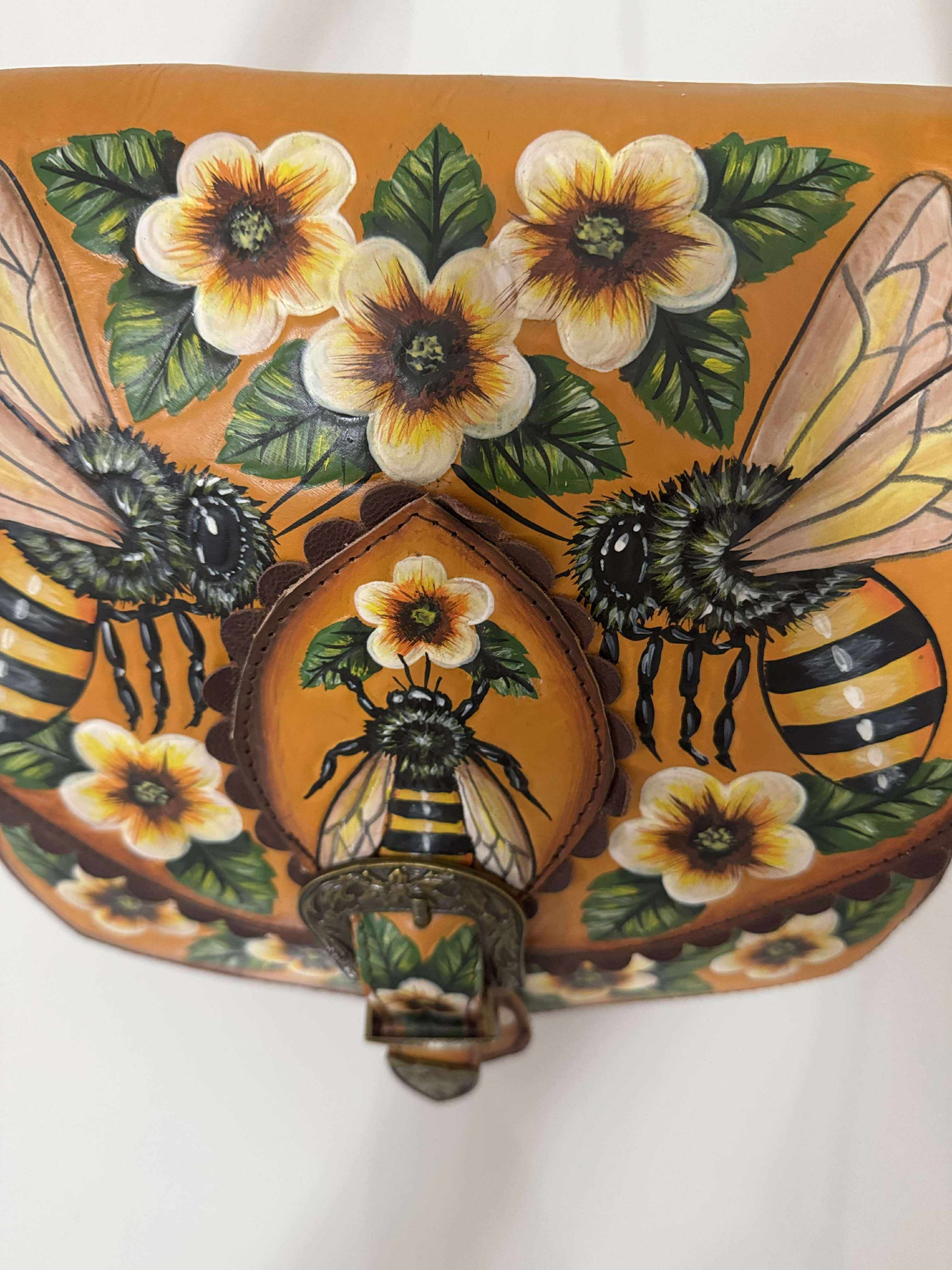 Decorative handbag with bees and flowers on a white background