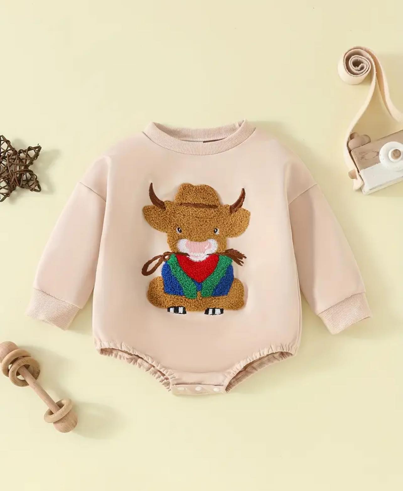 Close-up of the soft cotton fabric and embroidered bull design on the Behind the Bull romper, showcasing high-quality craftsmanship and Western charm.