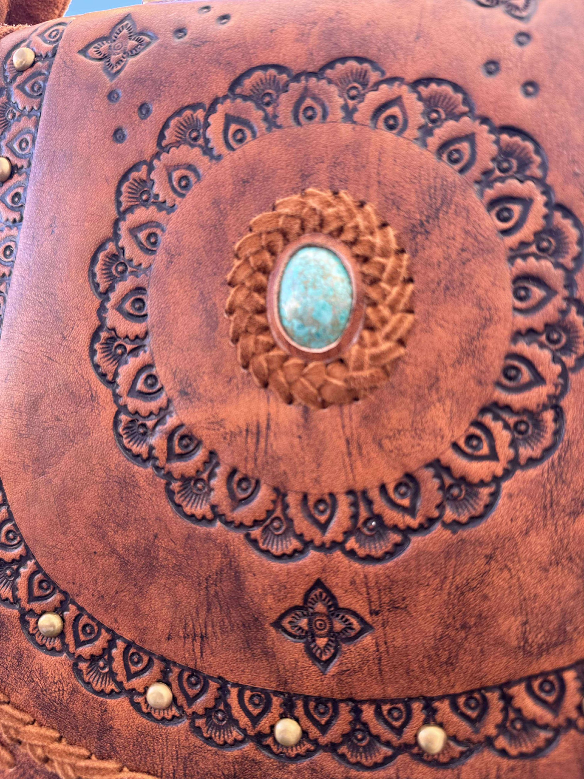 Artisan-made brown leather crossbody bag with floral tooling and natural stone – House of Hide’s small batch, ethically made fringe handbag.