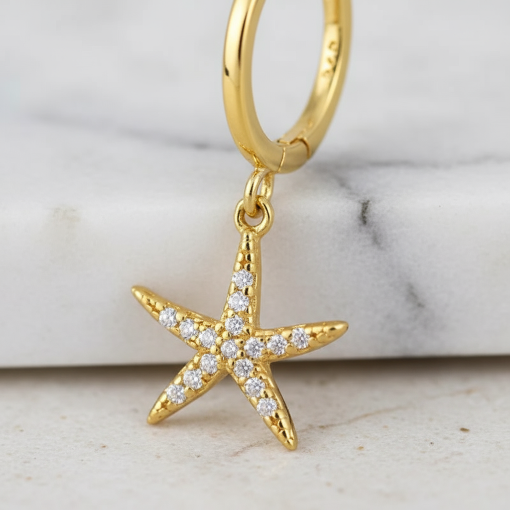 Polished gold hoop earrings featuring shimmering zircon starfish – Houseofhide Perth Australia