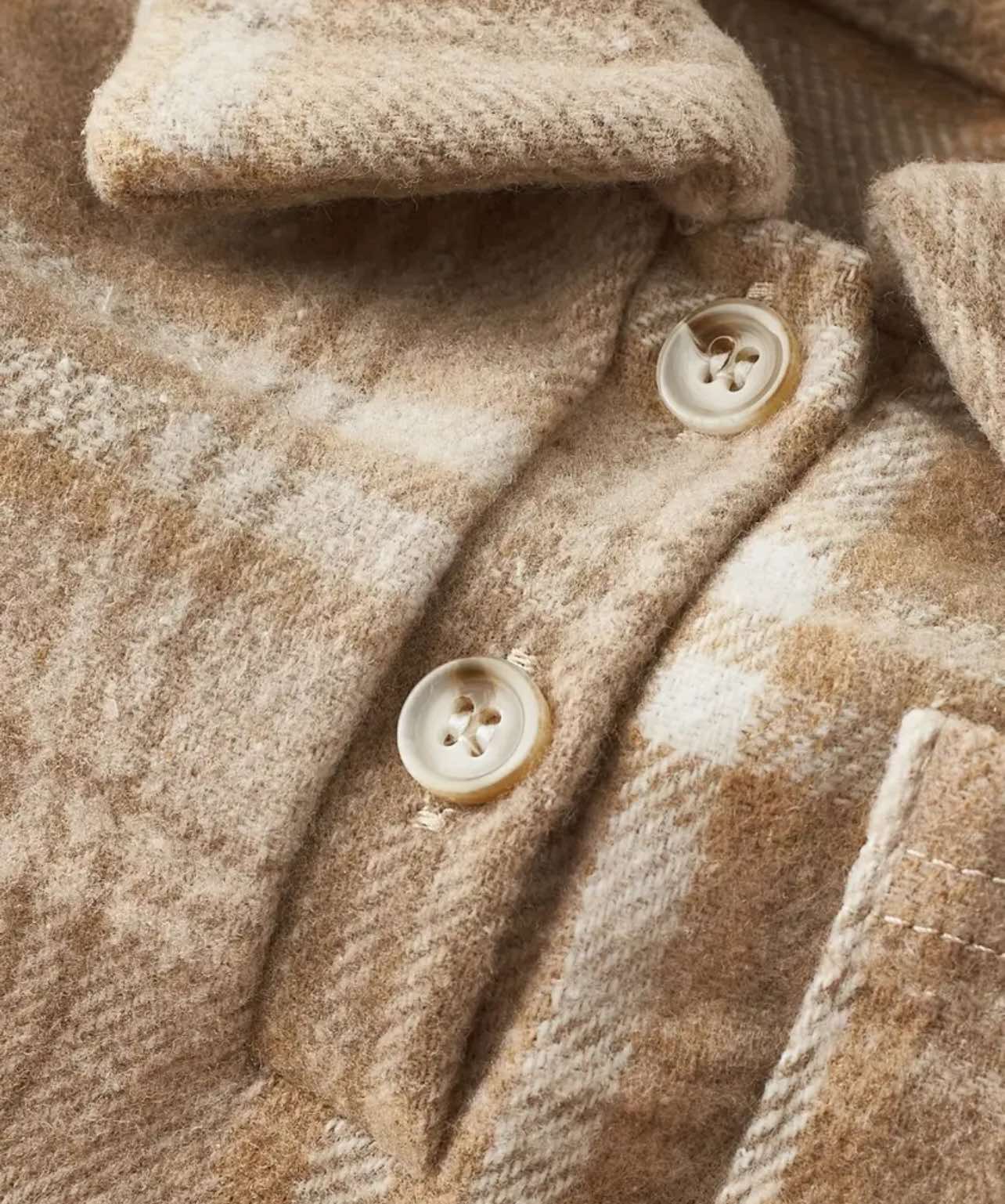 Brown long-sleeve flannel romper for toddlers, designed for comfort and style.