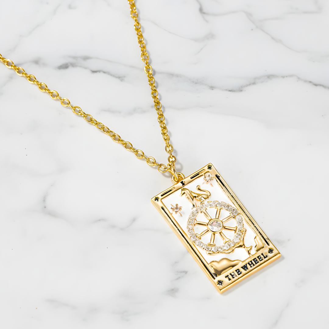 Gold rectangular pendant necklace by House of Hide Perth displayed on marble surface