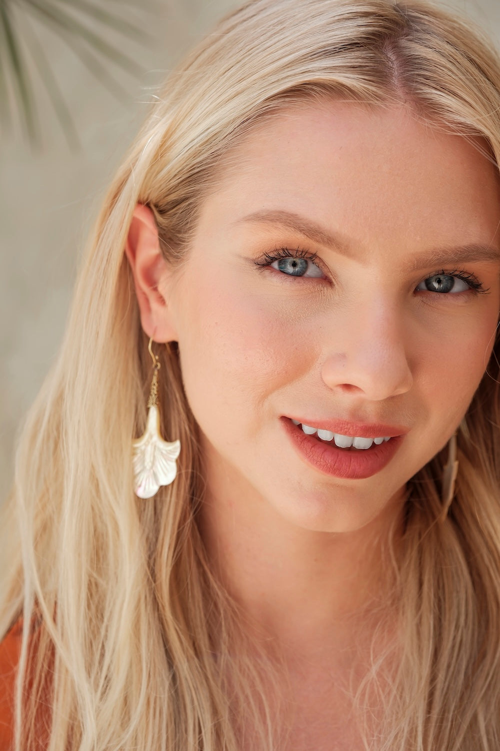  gold-plated pearl fan earrings with carved shell drops.