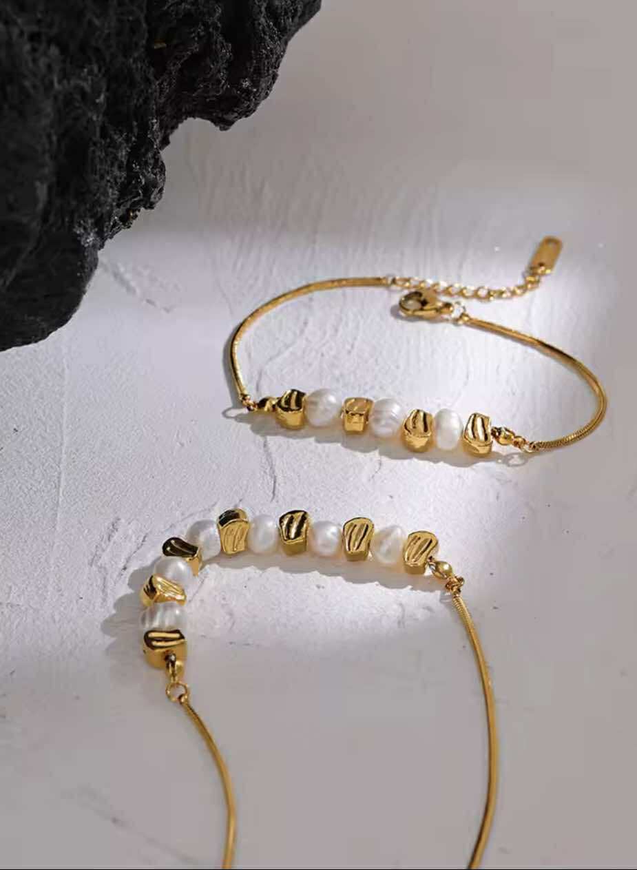 Close-up of adjustable gold stainless steel chain and pearl bead detail on the Golden Hour Bracelet.
