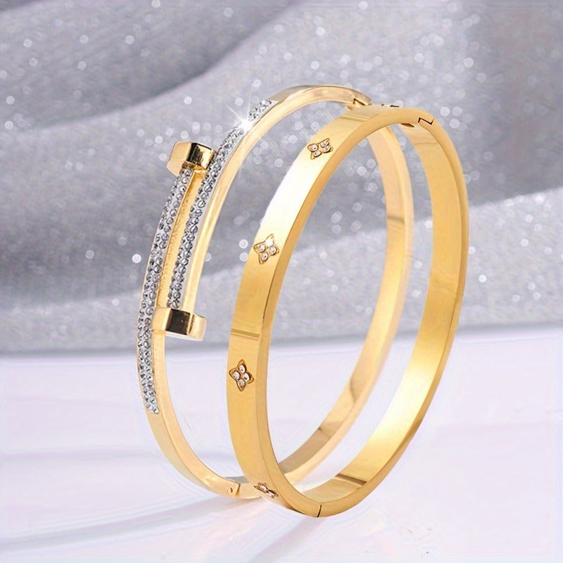 Gold stackable bangle bracelets, clover flower charm jewelry closeup, pave crystal everyday fashion accessory.