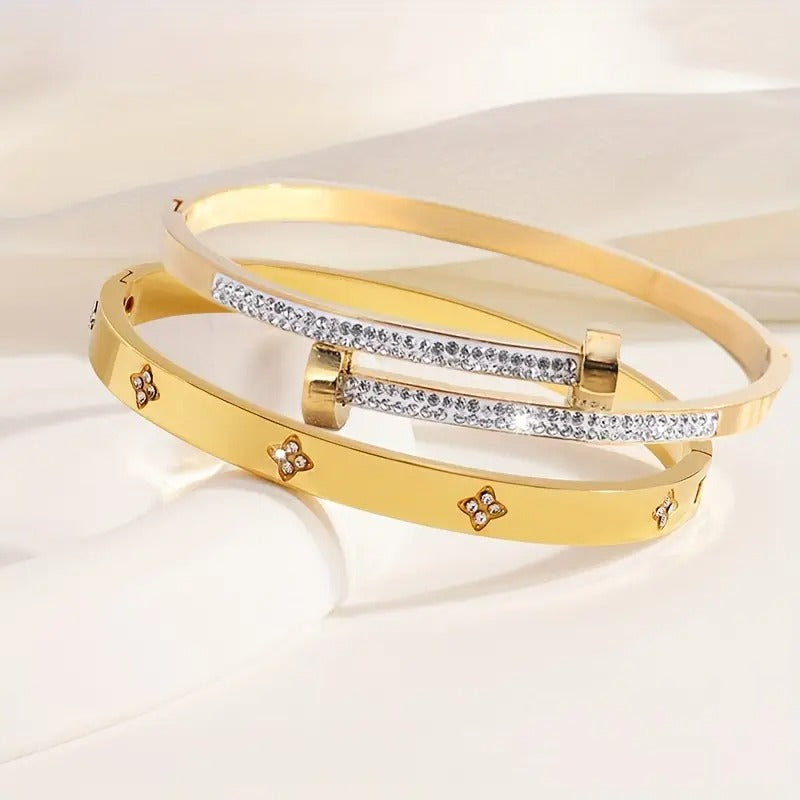 Gold stackable bangle bracelets, clover flower charm jewelry, pave crystal everyday fashion accessory.