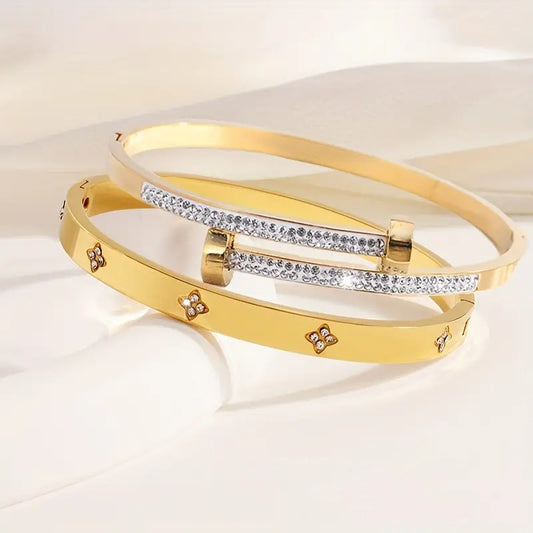 Gold stackable bangle bracelets, clover flower charm jewelry, pave crystal everyday fashion accessory.