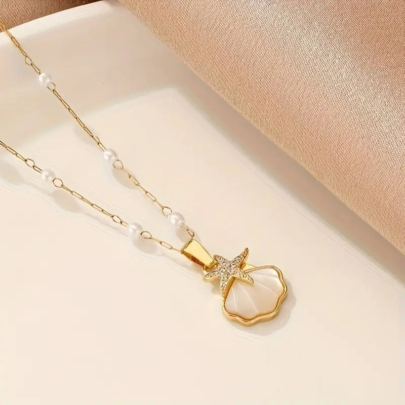 Golden pearl pendant necklace close-up view on a white surface