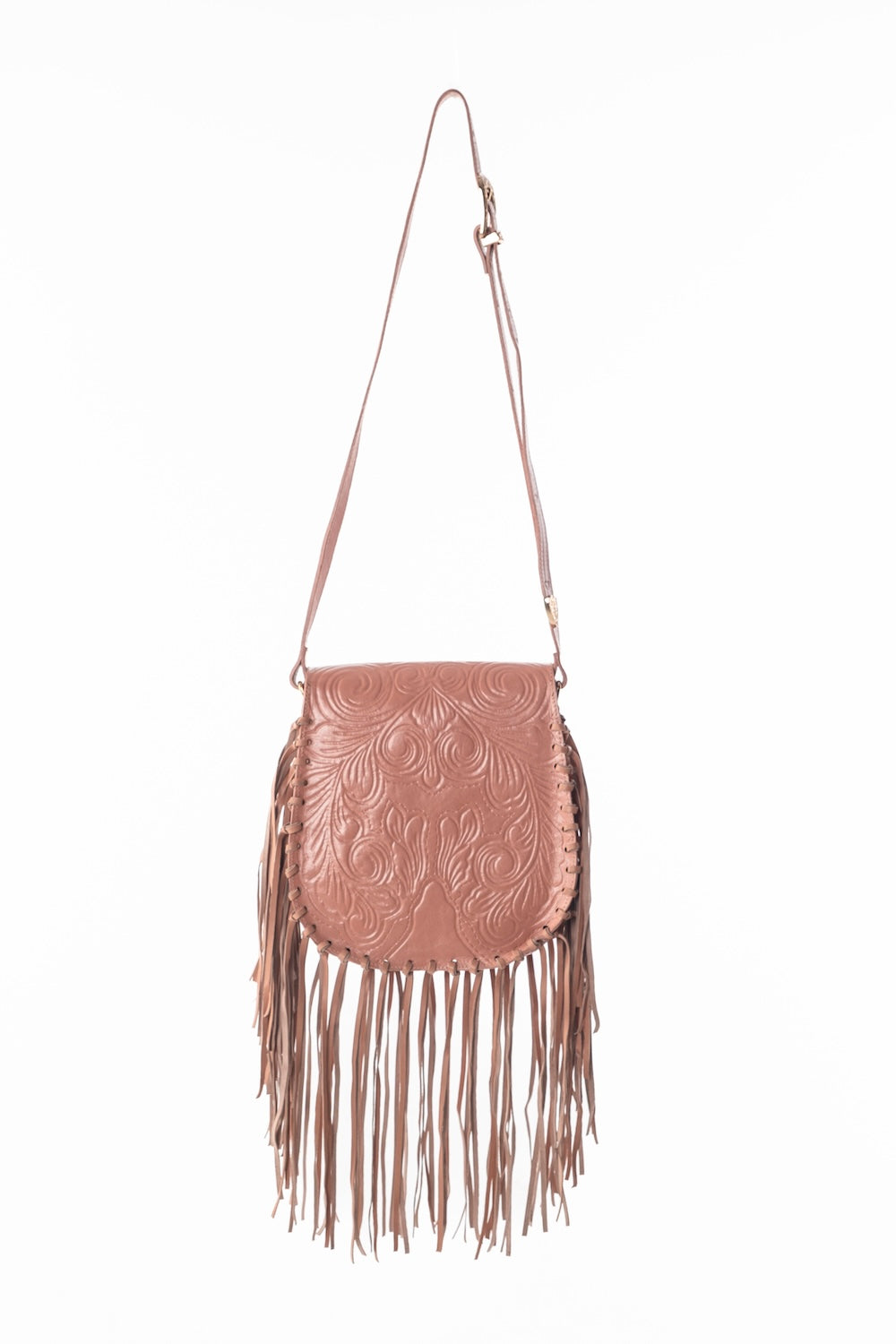 A structured hand-tooled leather crossbody in warm apricot, featuring intricate floral and paisley etching, rose gold hardware, and an adjustable strap—styled for everyday ease and boho charm.