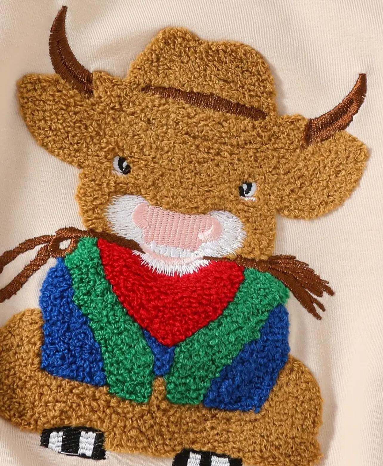 Flat lay of the Behind the Bull baby romper, a cozy and breathable country-inspired outfit designed for little cowboys and cowgirls aged 0-18 months.
