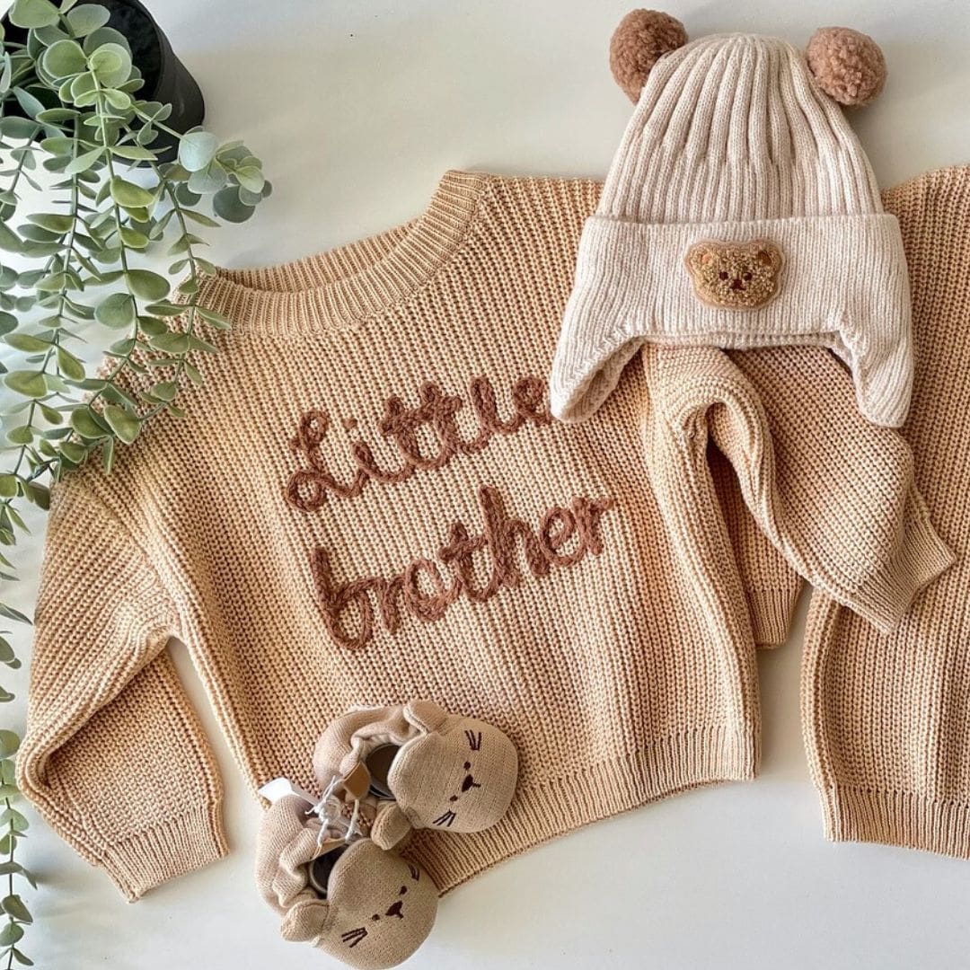 Sibling outfit set featuring baby in Little Brother jumper