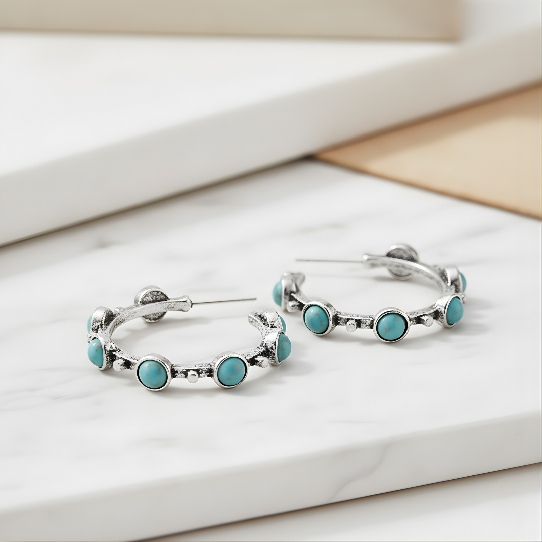 Luna Tide Earrings displayed on white surface handcrafted silver and turquoise hoops