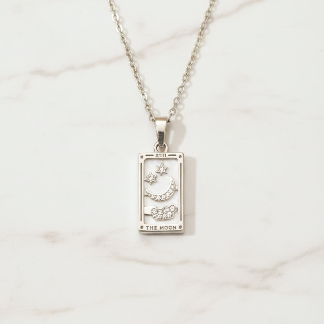 Moonlit Lagoon Necklace displayed on white surface silver chain with The Moon pendant design