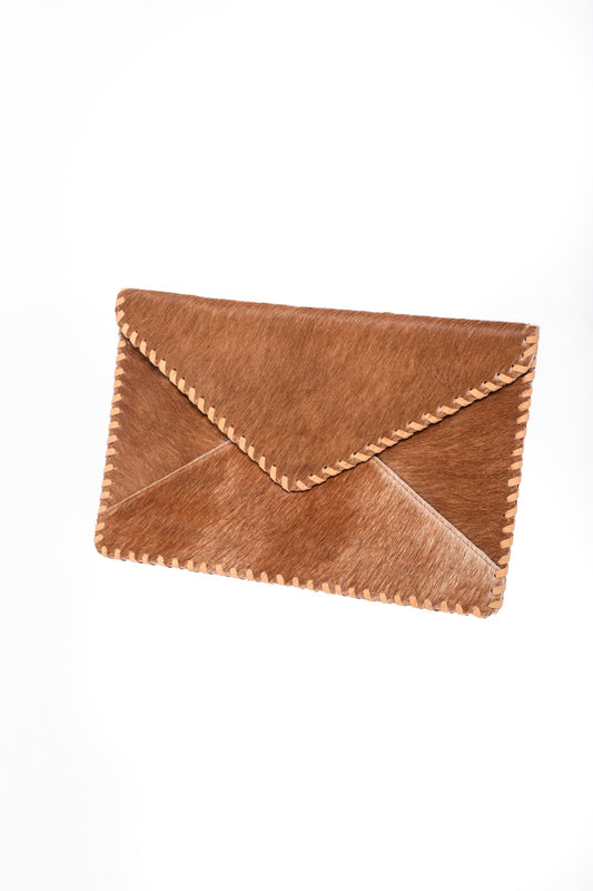 Handmade natural grain tan cowhide clutch purse, envelope design with faux suede lining and rustic artisan stitching.