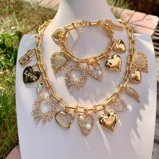 Gold charm chain on a mannequin with grass and stone background
