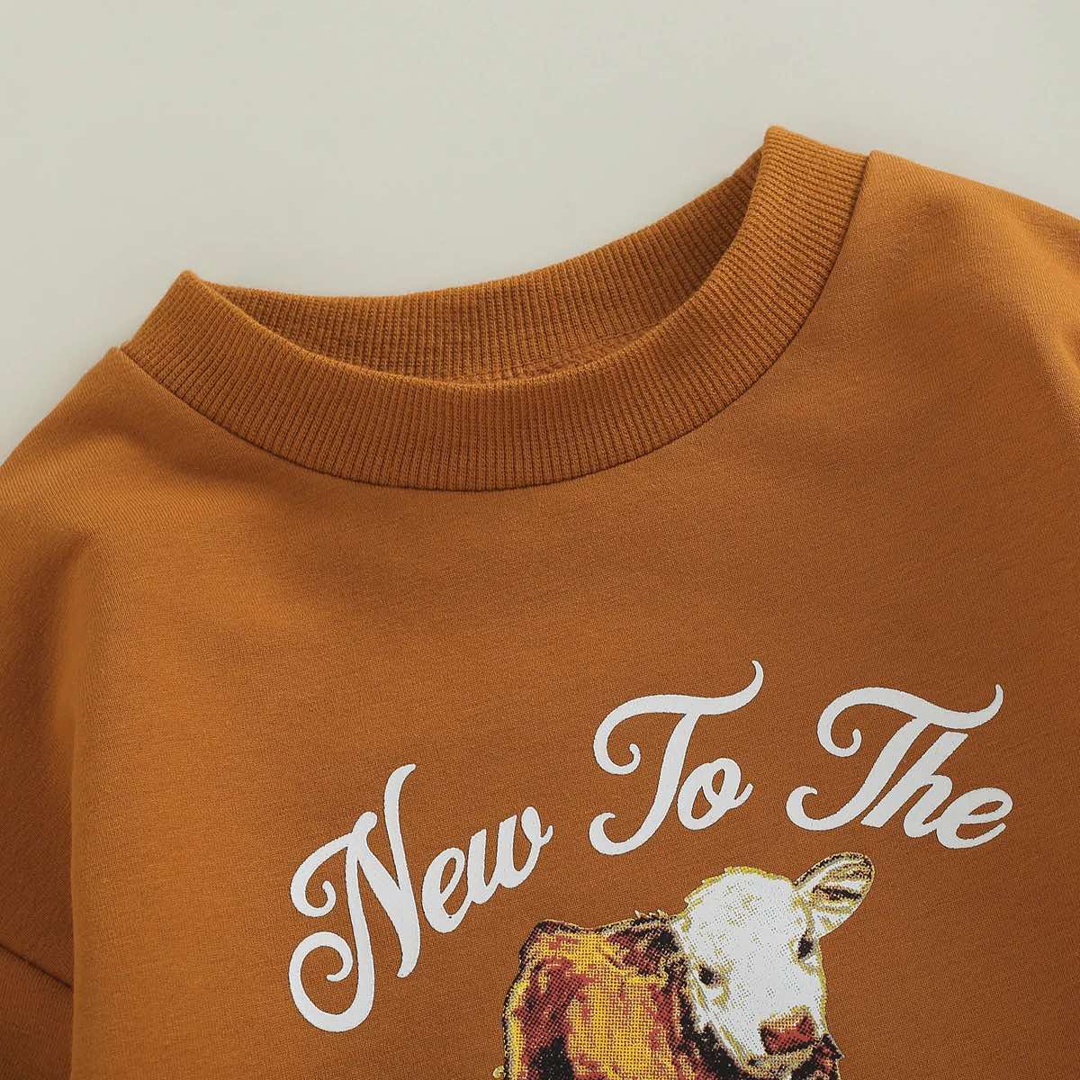 "New to the Herd" Western baby romper – cow print sweatshirt for newborns and toddlers.