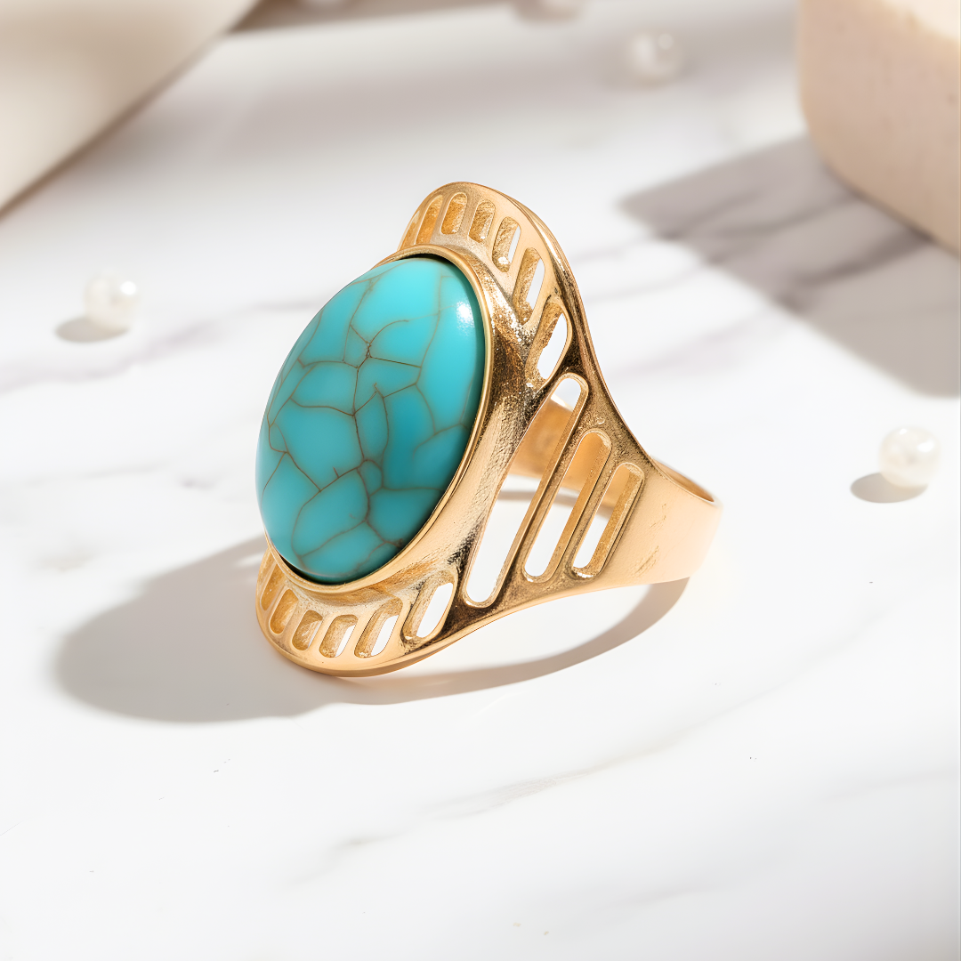 Paradise Gleam Ring featuring gold band with turquoise centerpiece on marble background