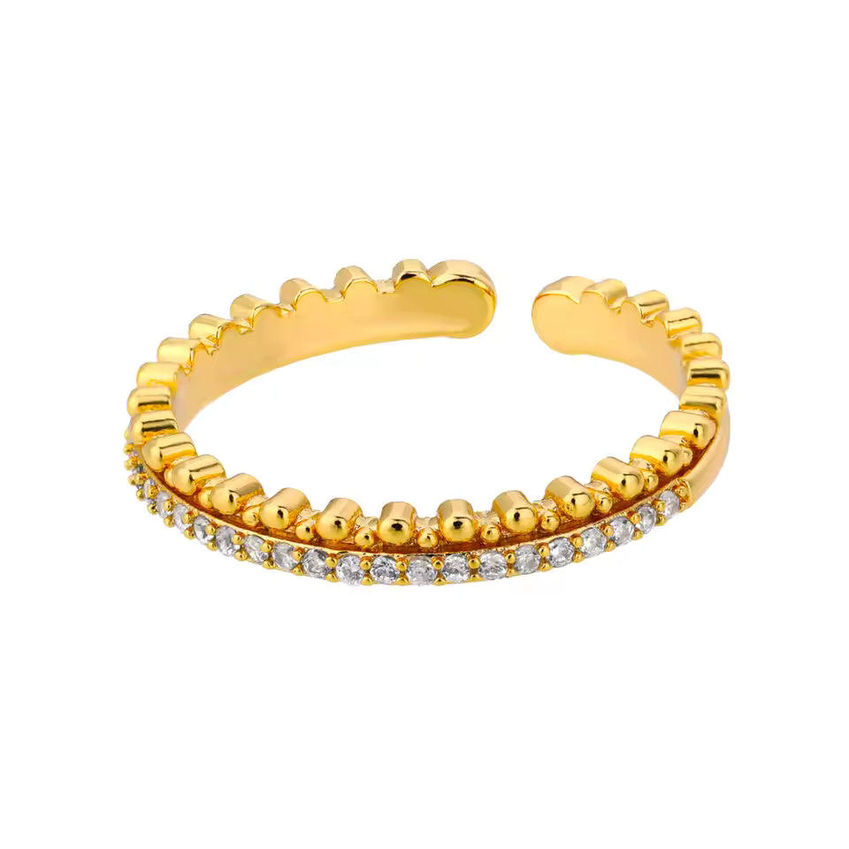 Gold open ring with small diamonds on a white background