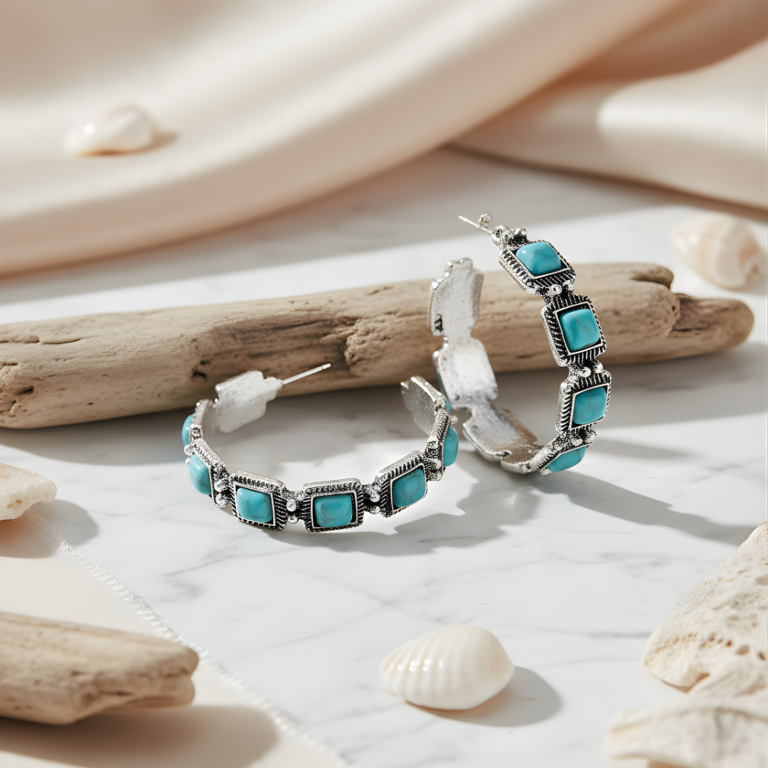 Tidal Breeze Earrings featuring silver design with turquoise gemstones on white surface