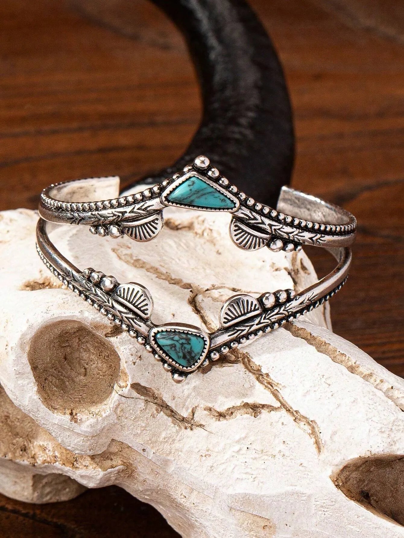 Turquoise cuff bangle bracelet on a textured surface