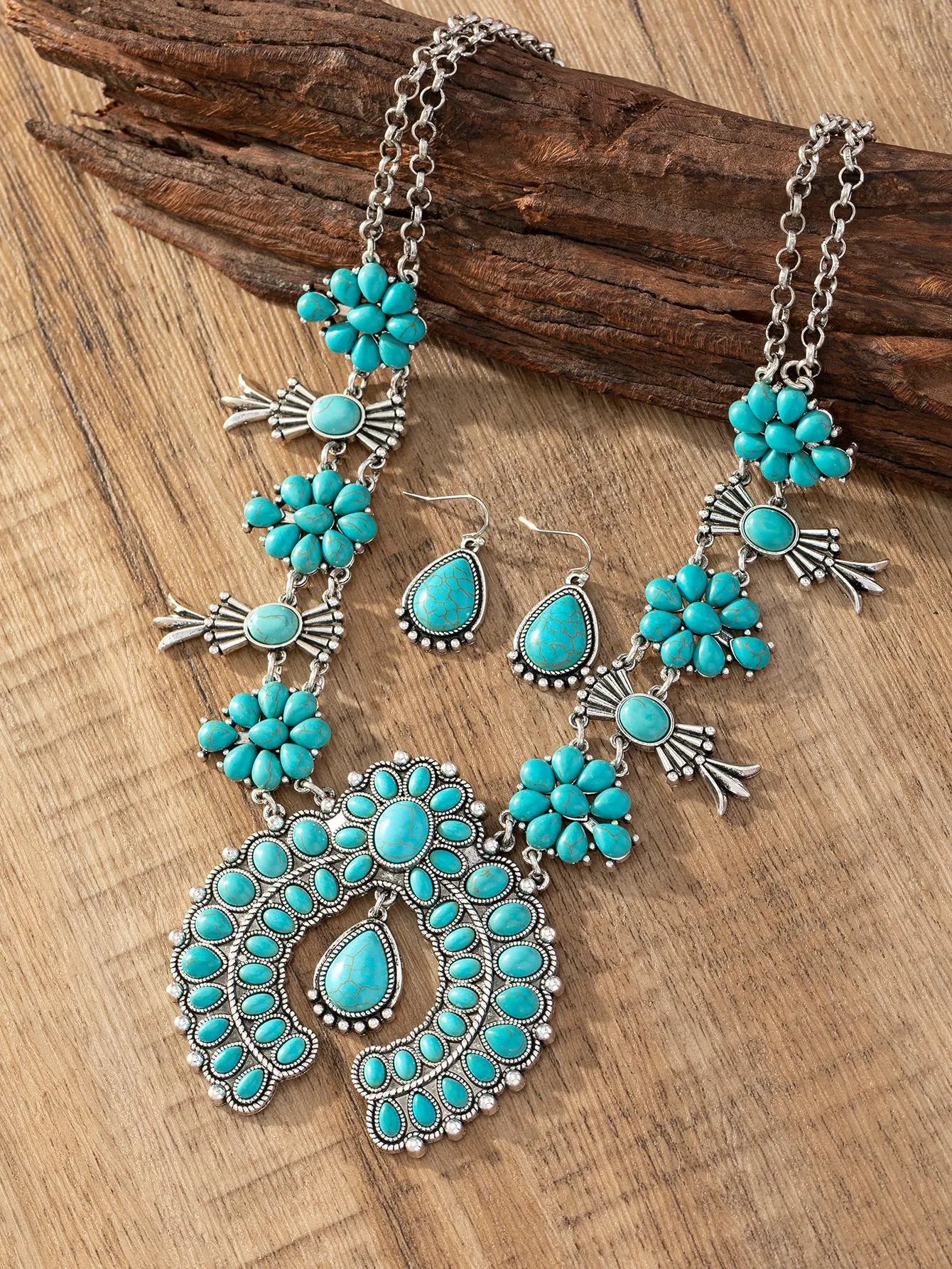 Turquoise pendant necklace set on a wooden surface