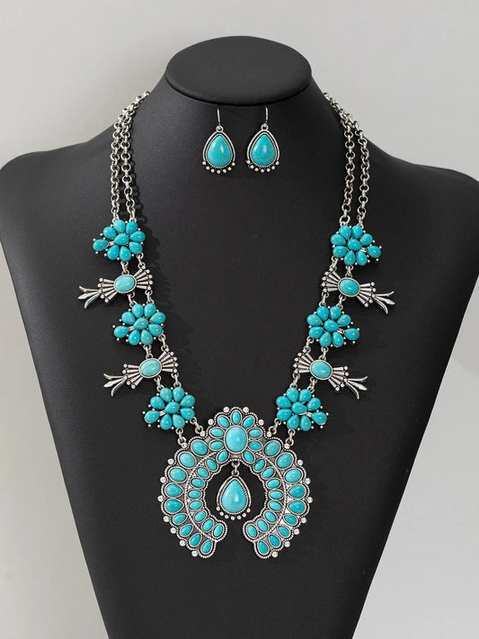 Turquoise pendant necklace on a black mannequin with a gray background