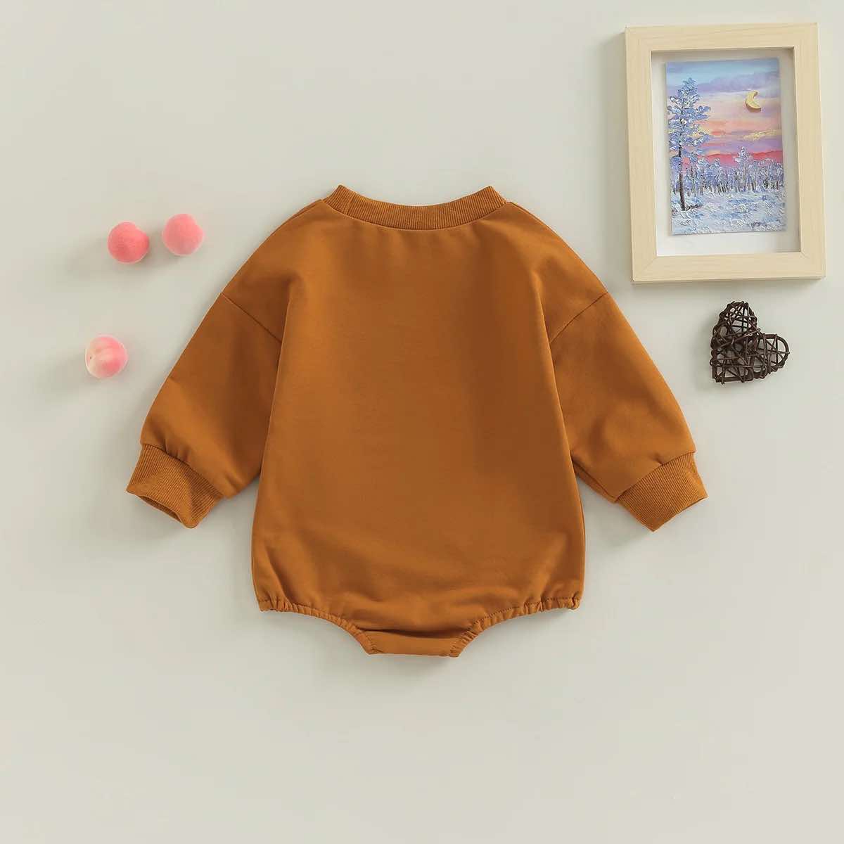 Adorable Western baby boy and girl romper with farm-inspired cow print design.