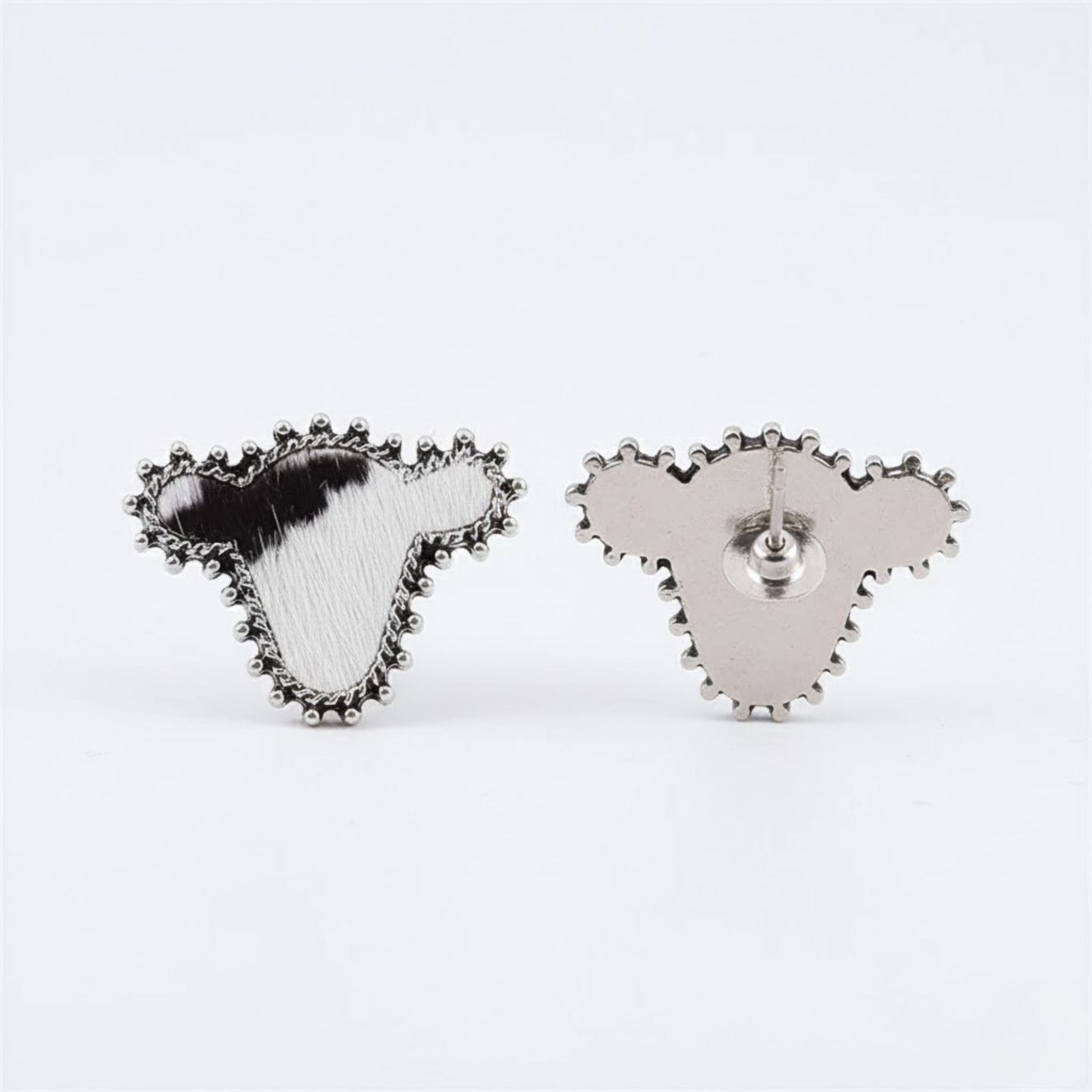 Western Cattle Cove Studs Perth Australia Houseofhide close up of handmade cow inspired stainless steel studs